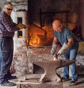 At the smithy, shaping the metal