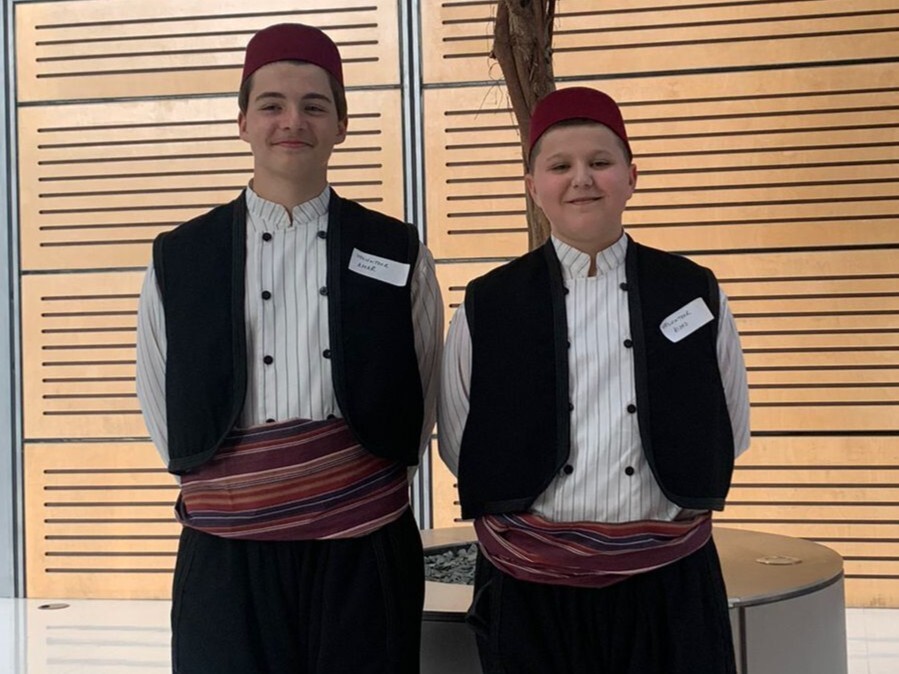 Two young volunteers in traditional Bosnian mean costume