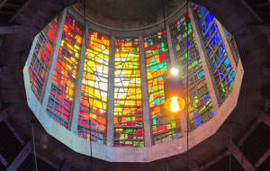 Looking up into a circular area with stained glass on the outside