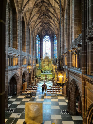 A view along a tall apparently narrow church space to the east window