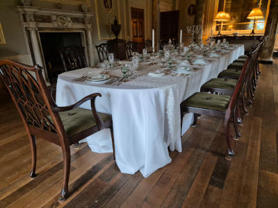 A long dining table complete with place settings