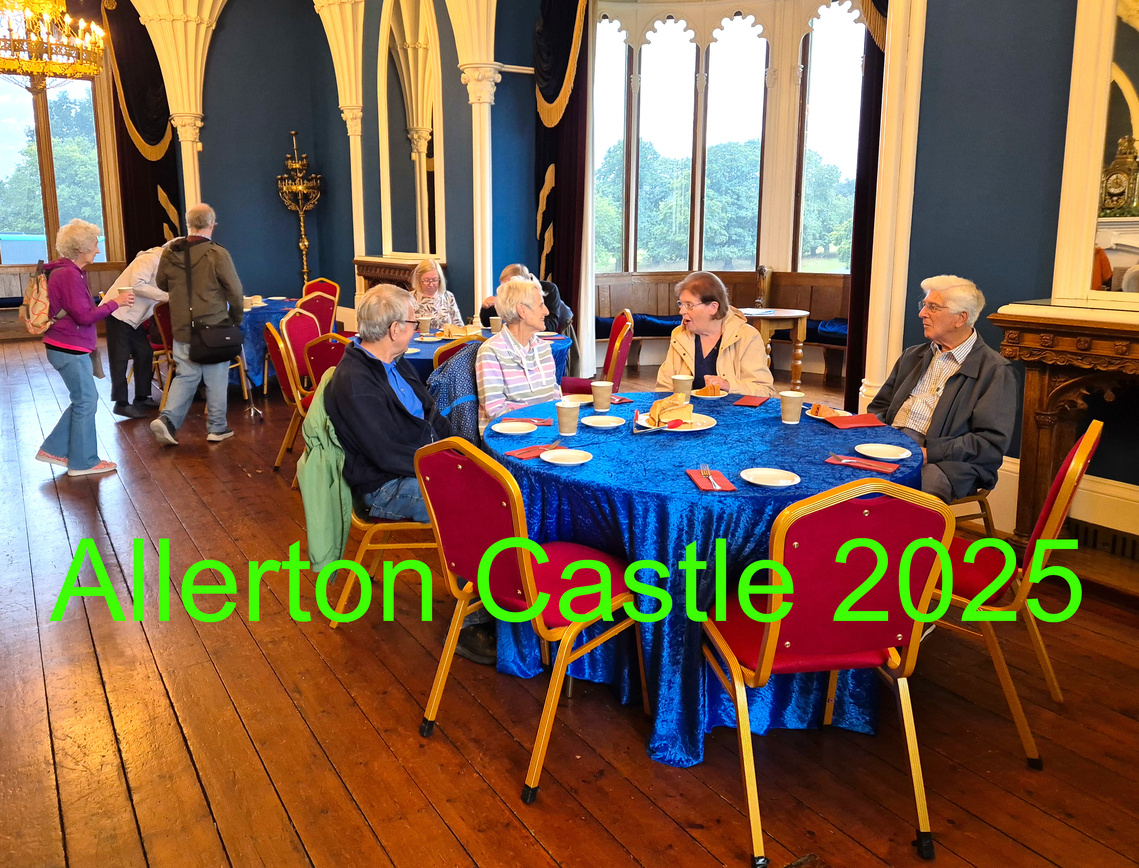 People sitting at dining tables in Gothic hall