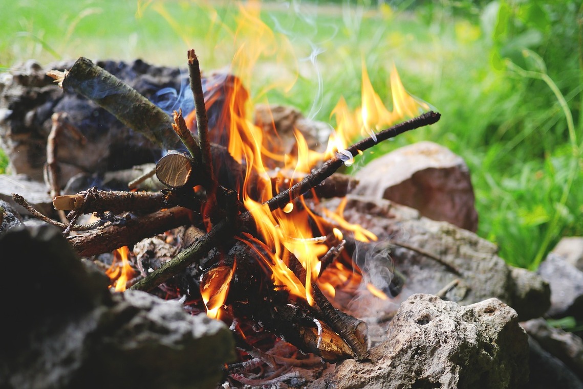 Afternoon daylight, a small campfire with flames looks inviting. Thanks t LUM3N on Pixabay for this image