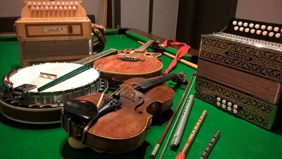 Accordian, banjo, fiddle and Bodhran on green baize