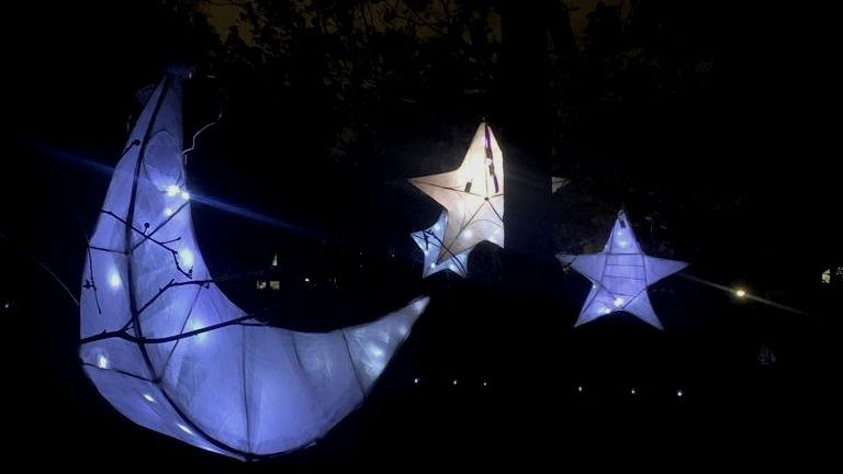 crescent shaped moon lantern and other plus person