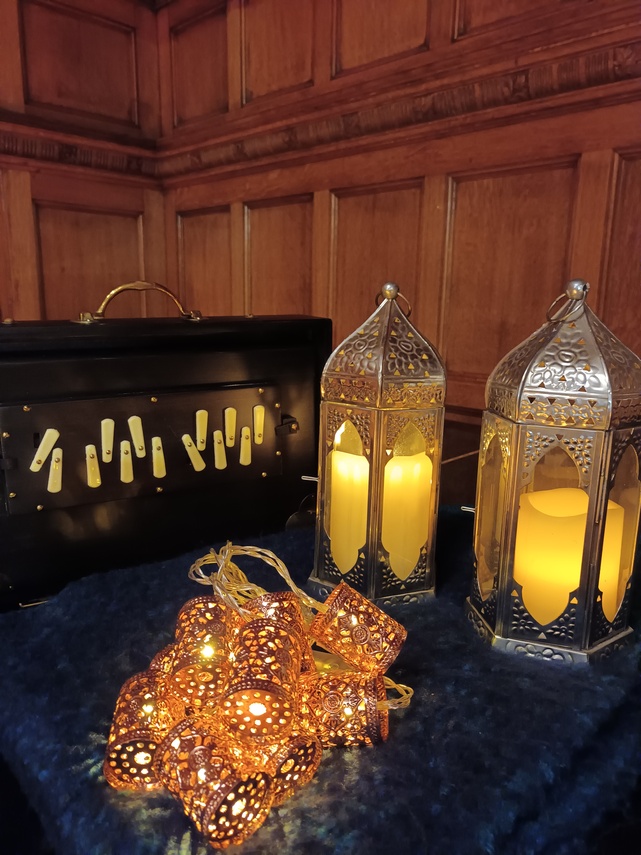 Shruti box, lights and lanterns glowing.