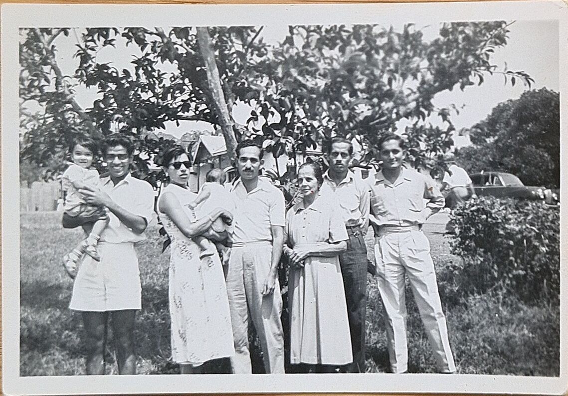 Kampala 1956 - L to R, Toddler Claude being carried, Grace carrying baby Christopher, and Narciso 