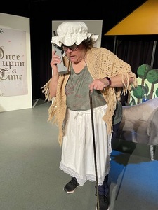 Sally playing the grandma from 'Little Red Riding Hood' (referred to in the play as 'Little Red Riding Cap').