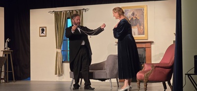 Dr Forbes giving Lady Diana the necklace in Murder Most Foul (the play inside the play)