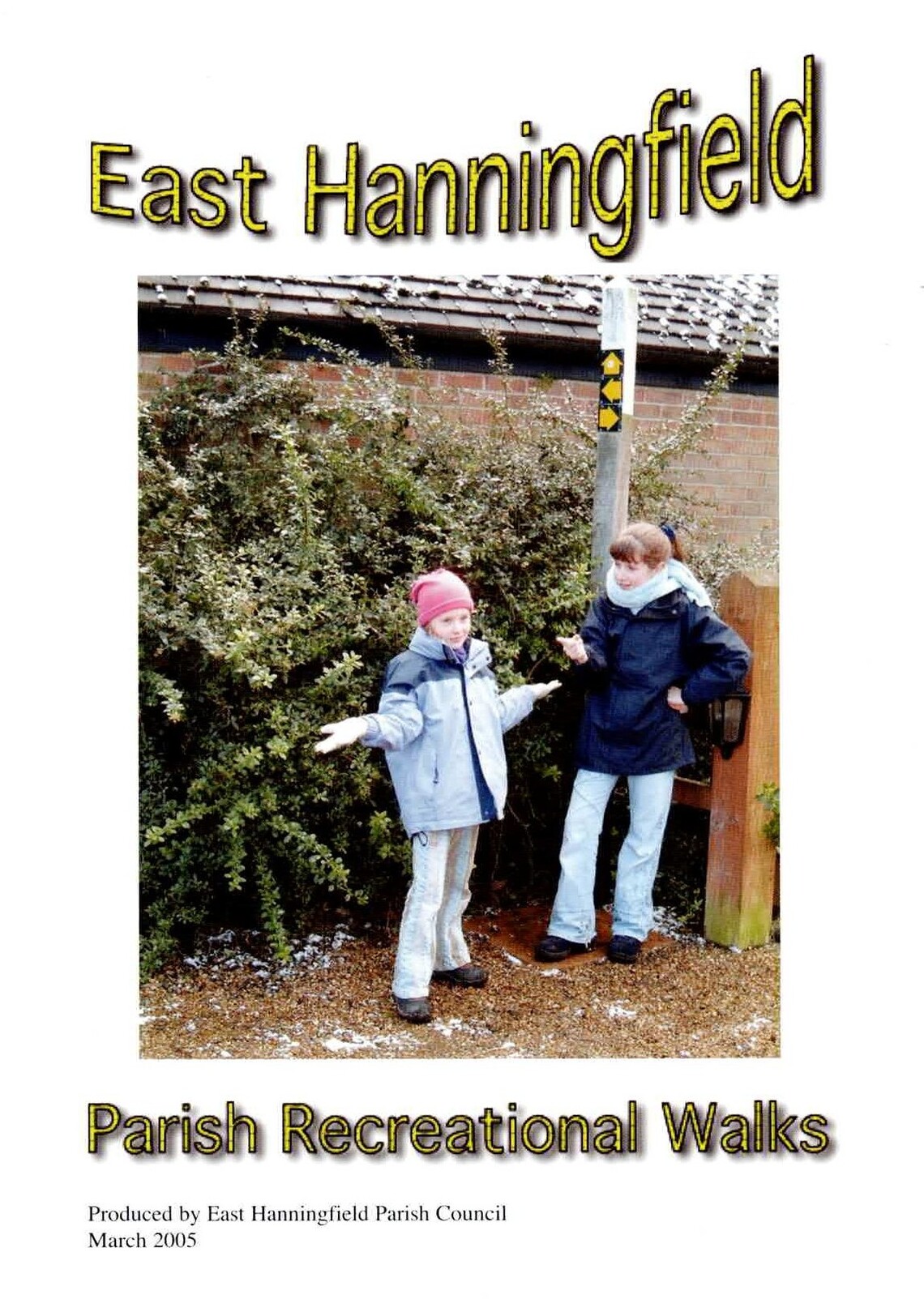Two young walkers standing beside a fingerpost.