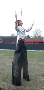 stilt walker juggling