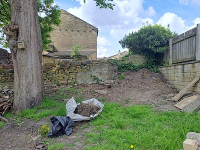 Work started in July 2023 to dig out the bags of rubbish that were dumped in the corner of the back wall in Section 3. 