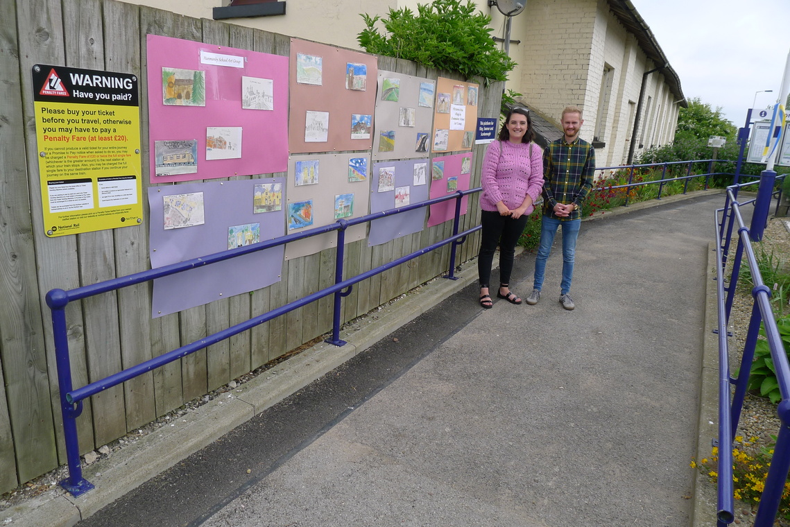 Putting up Hunmanby Primary School's Artwork at the village station