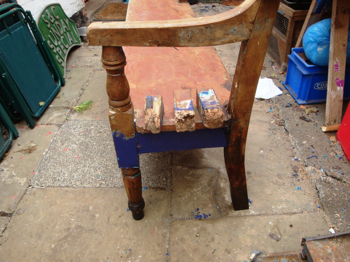Old Wooden railway Bench replacing rotten wood if its legs