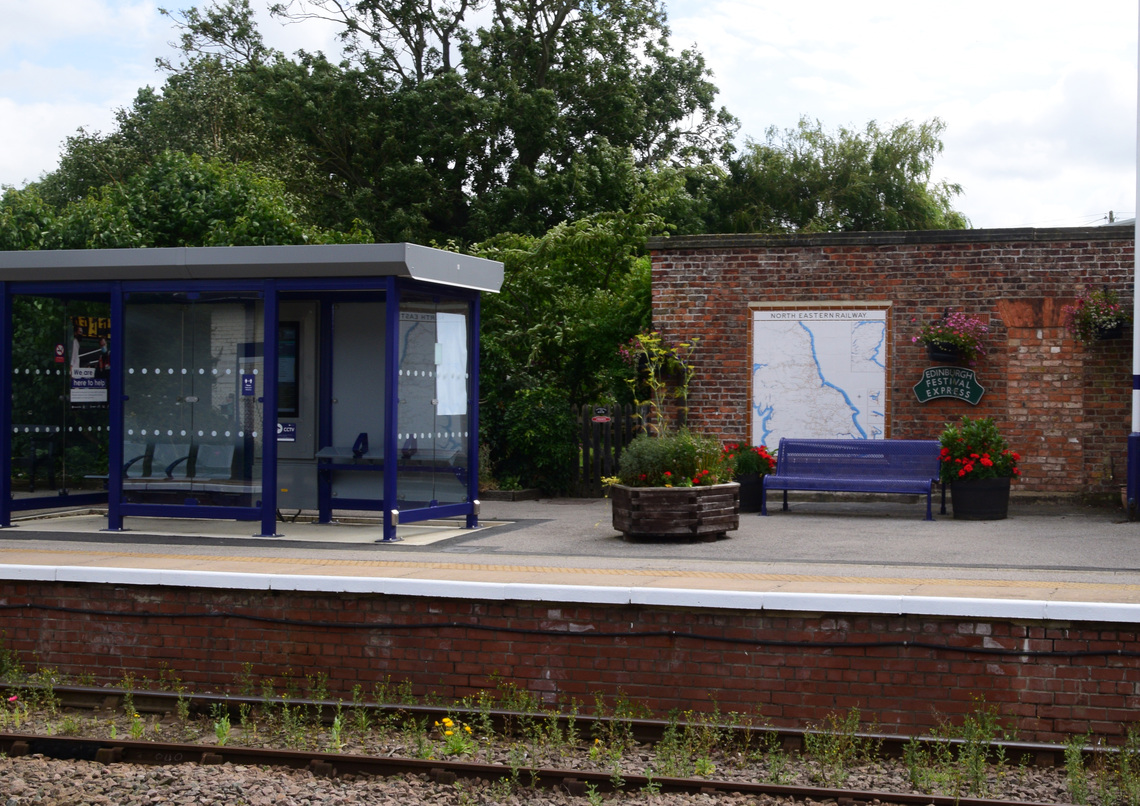 The North Eastern Railway Tile Map, 1840's hand made brick station house wall and modern waiting shelter