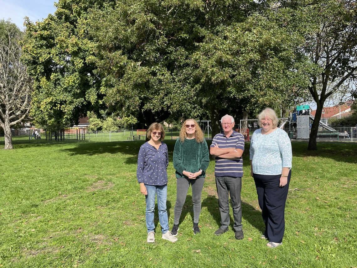 Four members of the committee standing in Nursery Green