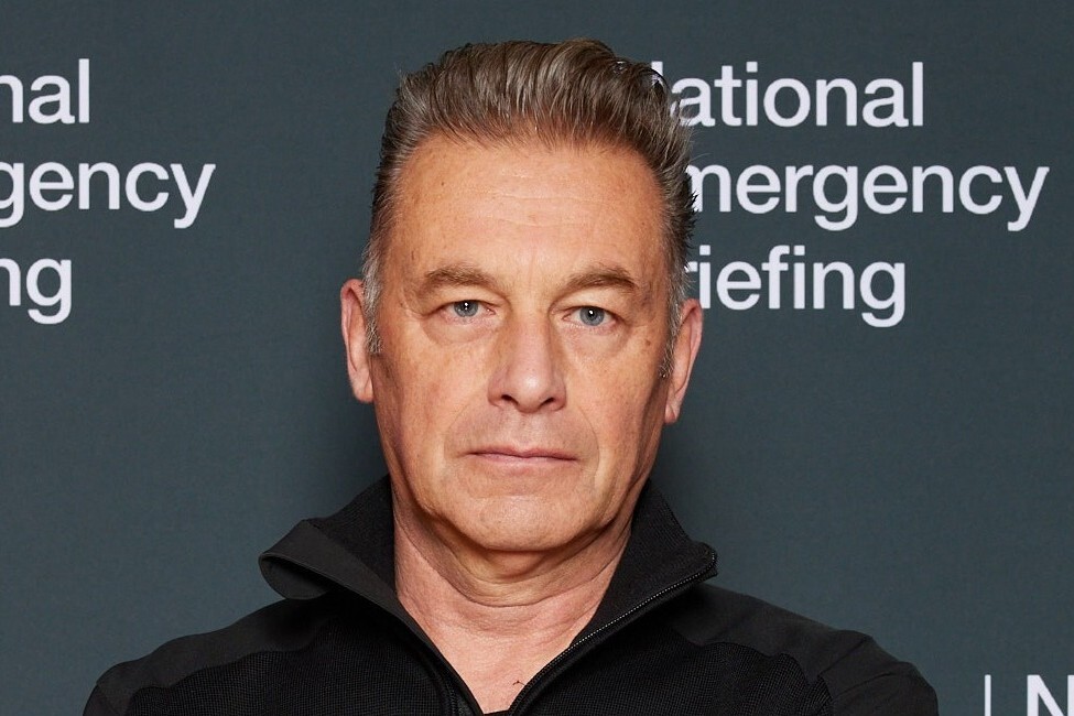 Chris Packham standing in front of National Emergency Briefing sign