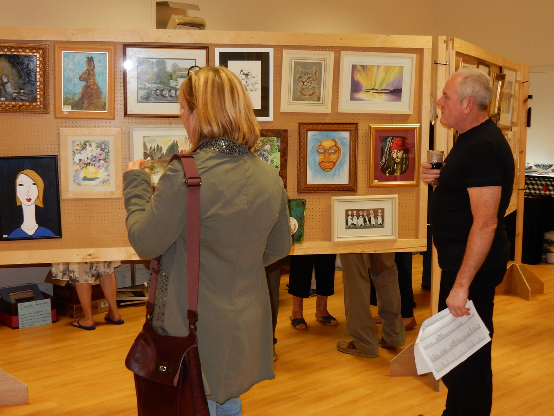 People browsing amongst the paintings