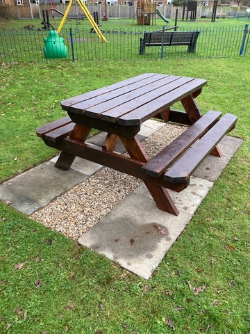 A picnic tables sited near the play area.