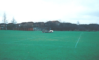 Burnt out car on a football pitch in the middle of the Common