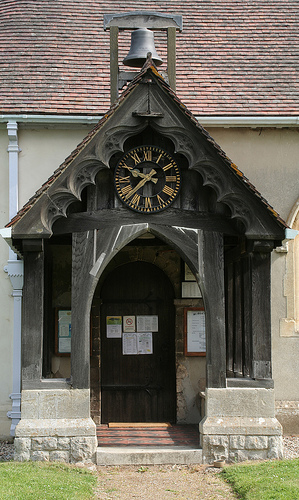 Church entrance and clock at St Giles Langford