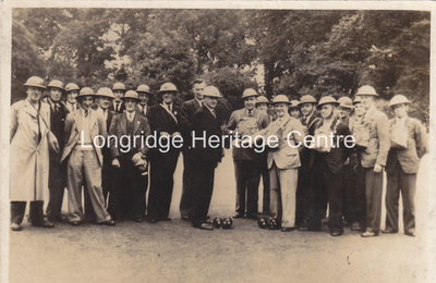 160C - Civil Defence Personnel - A bowling match in tin hats and gas masks - 1941