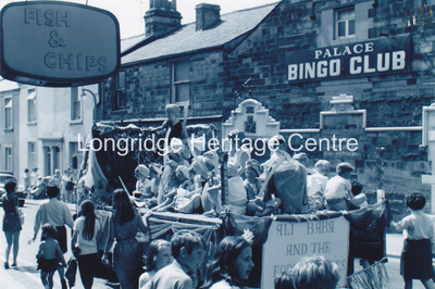 6994A - CP 67 Field Day Parade - Float passing Palace Bingo - 1970