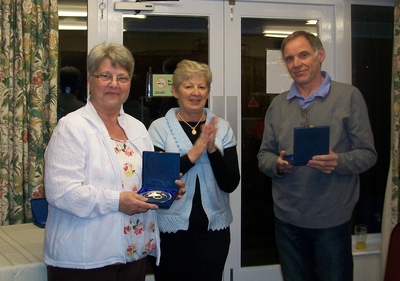 Pam Butler presenting John Boult and Lesley Brown with their trophies as winners of the Pairs 