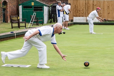 Trevor Day, a focused bowler, purveyor of pot plants and grass cutter.