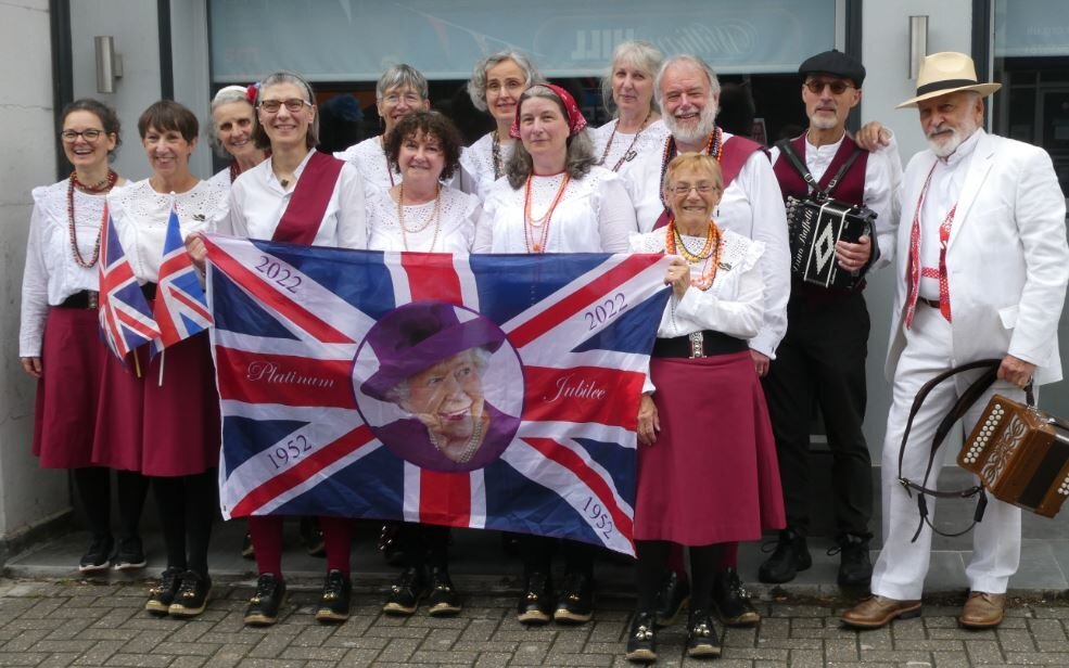 Phoenix Clog group holding a banner for the Queen&#39;s Platinum Jubilee