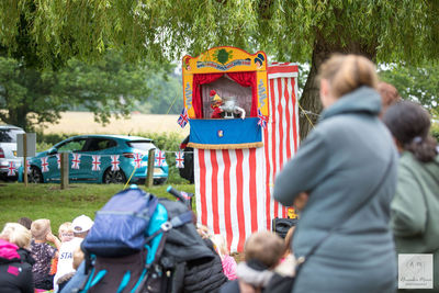 Children and parents enjoying Punch and Judy