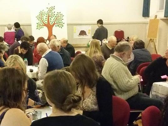 People sitting round tables discussing something