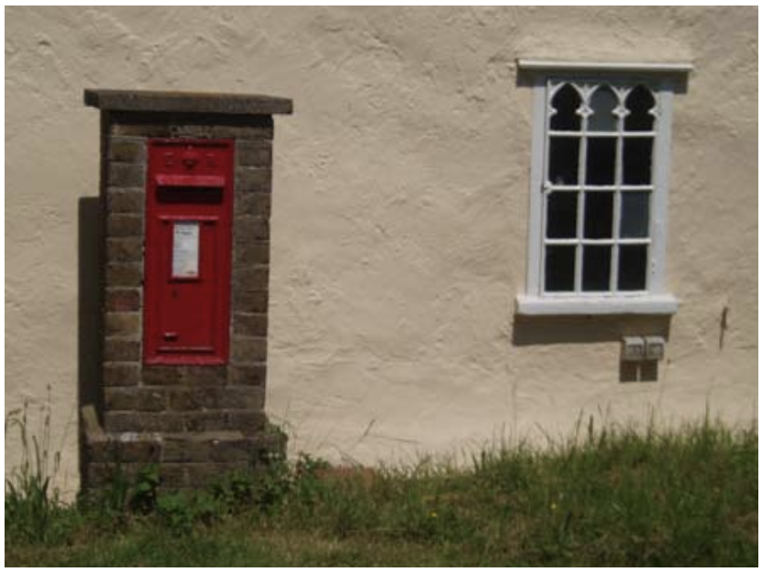 Red_letterbox_and_cast-iron_Gothic_window.png