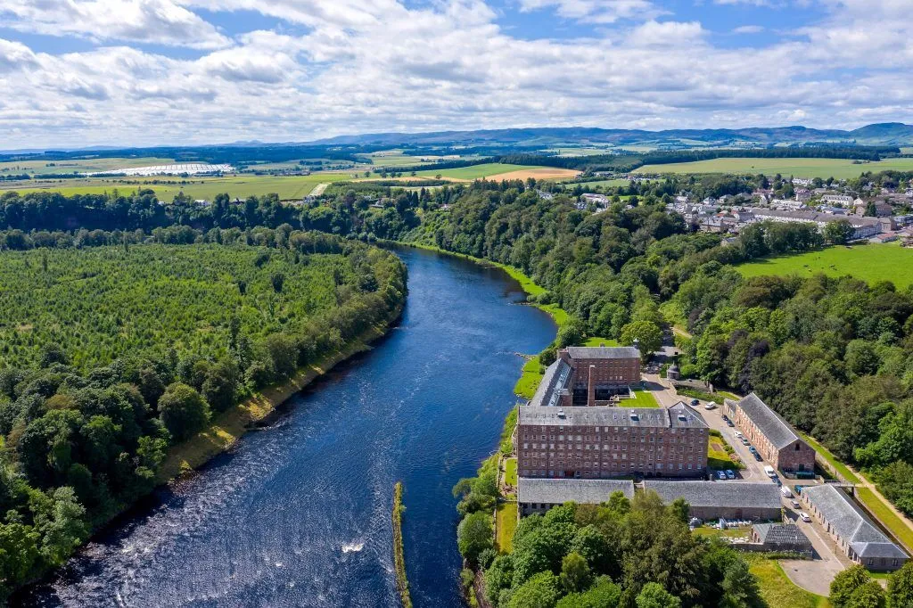 a photo shot from above Stanley Mill along the Rover Tay and showing th village of Stanley to the right