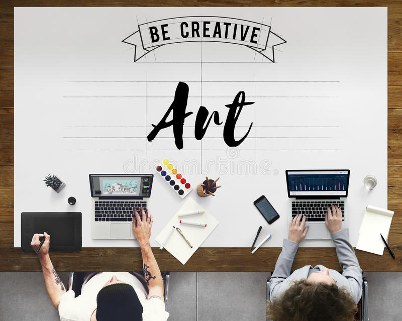 Image of two people working on laptops