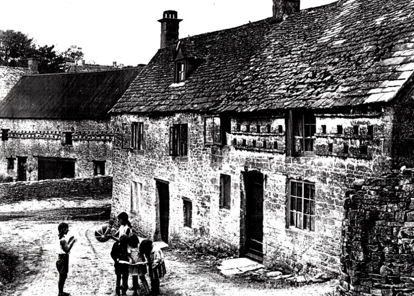 Duntisbourne Leer - view looking towards Leer Farm with 'Alices' in the foreground together with children playing to the front