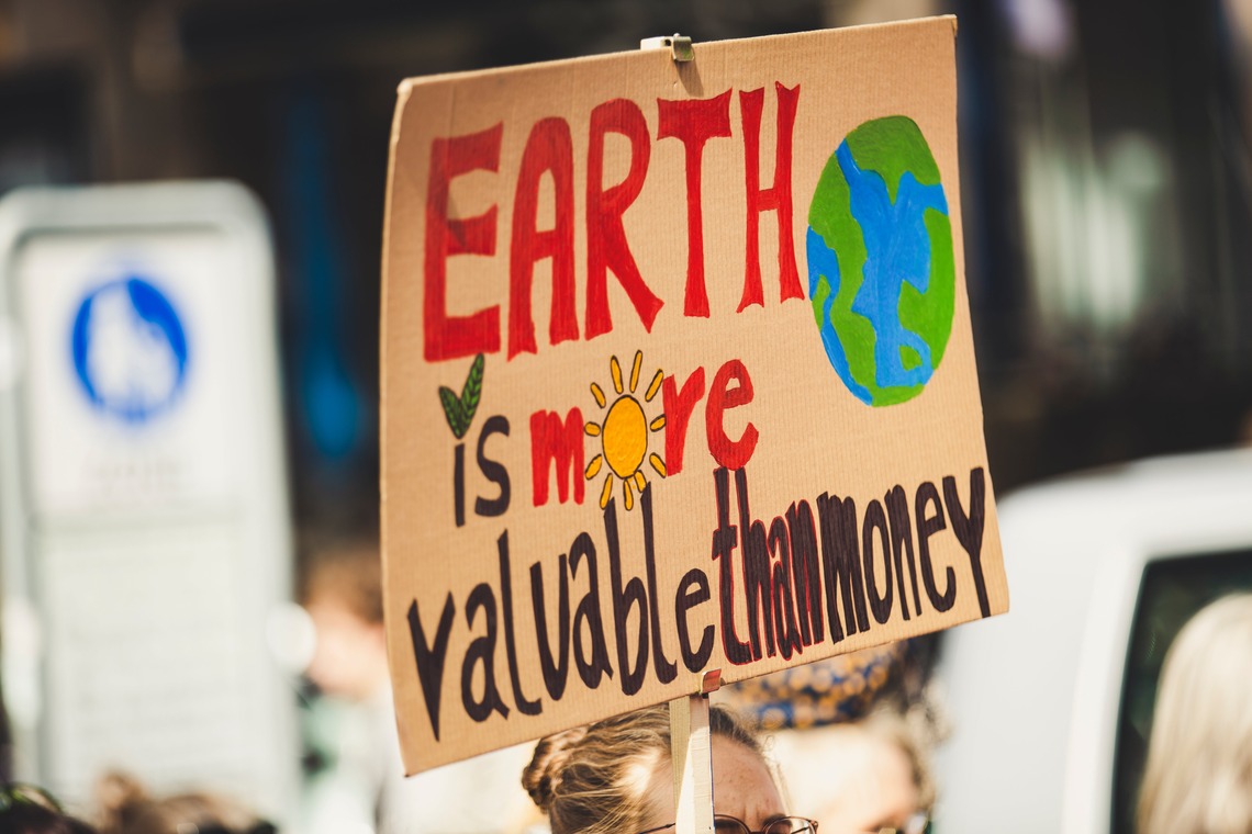 placard with the words Earth is more valuable than money