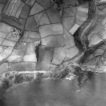 Church Road and Wembury beach occupy the east of the photo. In the north west the surviving evidence of open strip fields is clear. South of the ancient strips, a semi-circular feature is a major anti-aircraft battery, with ammunition stores, etc nearby. This was an important part of Plymouth's WWII defences. 
