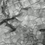 The village running roughly north-south is Down Thomas, with nearby  Gabber Farm in the south east corner. The ancient pattern of strip fields is once more very evident in the south. The deep valley in the north west is that leading down to Bovisand  beach. Bovisand Lodge appears as a cluster of buildings in this valley.  