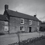 Knighton Farmhouse in the mid-1980s. Owned in the early 1950s by Ben Clifton, in 1953 it was bought by Henry (later Sir Henry) Studholme when the Cliftons moved to Eggbuckland. Henry Studholme put in a farm manager, Mr Stevenson, who remained there until the late 1980s. The picture shows the farmhouse just before the end of Mr Stevenson&rsquo;s time as tenant. Peter Lugar recalls the farm had a specially constructed sheep dip, to which other farmers brought their animals. When this was first used the headmistress of the school, Mrs Algate, was asked to calculate the dilution of the chemical to ensure there were no dire consequences!
