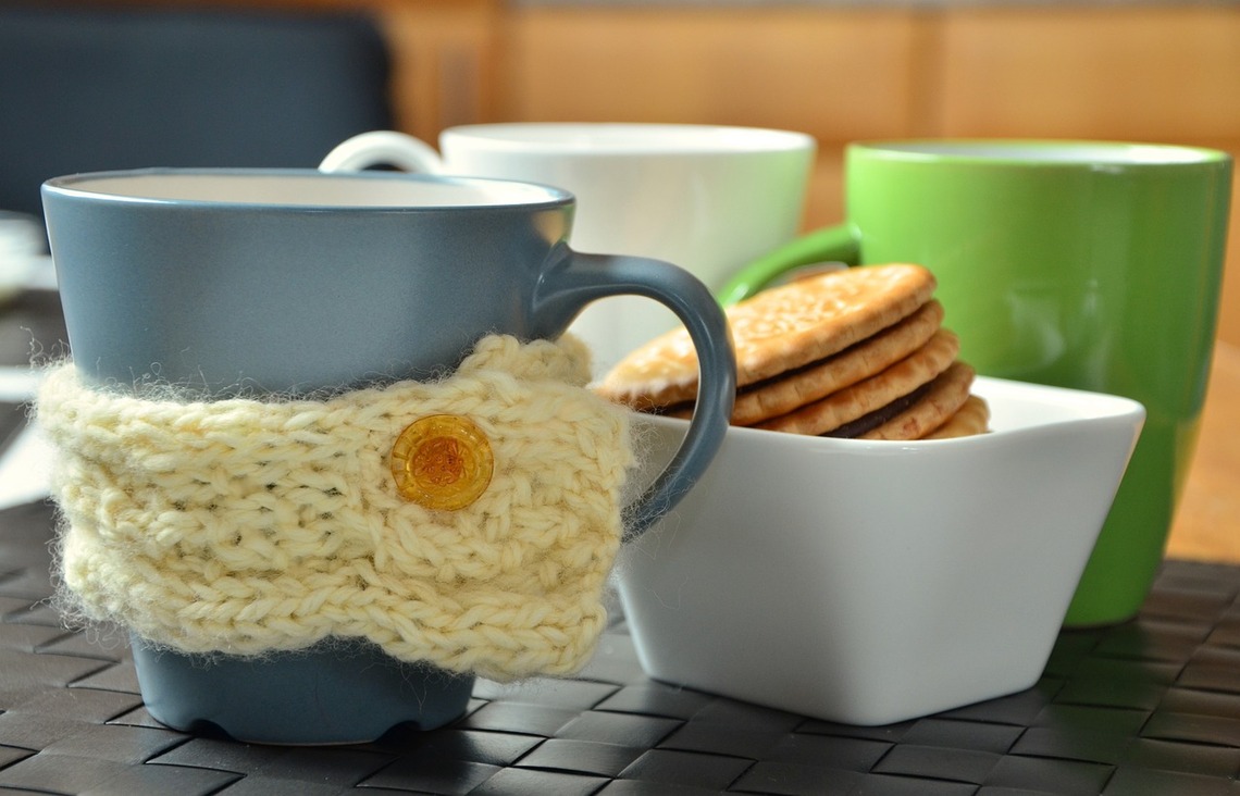 a cup with a knitted warmer